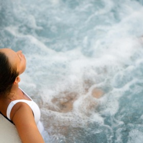 overhead stock photo of woman lounging in a large jacuzzi